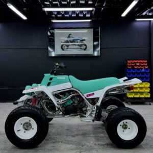 ⚙️ Key Specifications Engine: 347cc, twin-cylinder, 2-stroke Transmission: 6-speed manual Drive: Chain-driven rear wheel (2WD) Cooling: Liquid-cooled system Fuel system: Dual carburetors 🚀 Performance Extremely fast acceleration for its era Lightweight chassis for sharp handling Strong power delivery (aggressive 2-stroke feel) Built for sand dunes, trails, and racing use 🔥 Highlights Classic early-production Banshee model Highly collectible and sought after today Easy to modify with huge aftermarket support Famous loud “2-stroke twin” sound